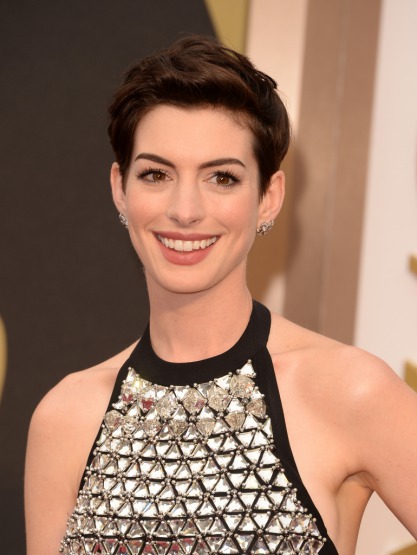 Anne Hathaway, doğal makyaj, sıcak kestane saçlar, minimal göz kalemi, porselen ten ve dolgun dudaklarıyla tanınır. Gülümsemesi güzelliğinin imzasıdır.